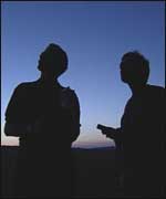 Chris Packham and bat worker scanning the sky at dusk