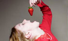 The Truth about Food (image: a girl eats a strawberry)