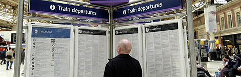 Man looking at train timetables