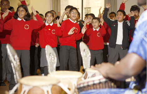 Children watching African drummers perform