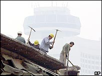 Trabalhadores demolem um edifício residencial em Pequim