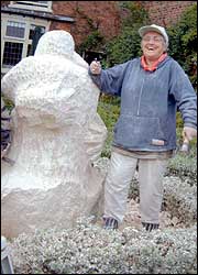 Sculpture and artist, side by side.