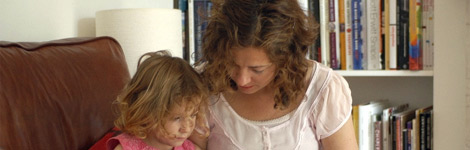 Woman reading a story to a girl