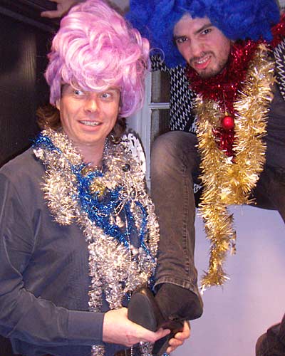 The ugly sisters try on the slipper.