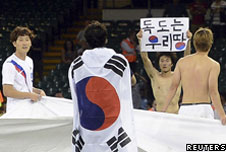Park Jong-woo holding a sign
