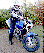 Chris Sandys sat astride his new motorbike