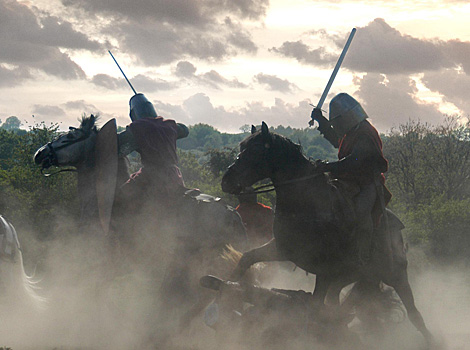 Knights on horseback fight each other in a battle
