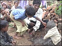 प्रतिमा की पूजा करते बच्चे