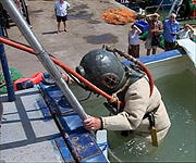 Jim Hutchison getting ready to descend into the water in full diving gear