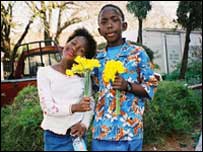 School kids bearing flowers