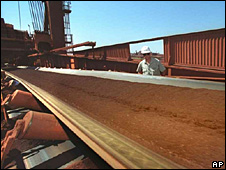 A conveyor belt filled with iron ore