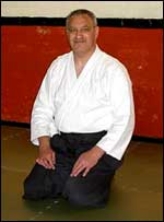 Man squatting in akido pose