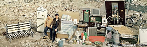 Huang Qingju's photo of a family outside their house