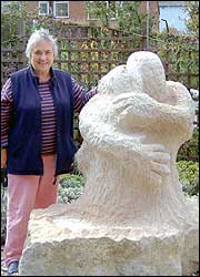 Woman standing next to a statue