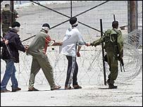 Soldado israelense leva prisioneiros palestinos