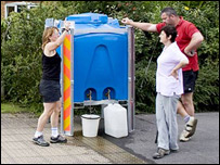 pessoas enchem galões