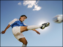 A footballer kicking a ball