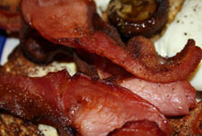 A cooked breakfast of bacon and eggs