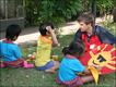 A volunteer doing arts and crafts with three young residents.