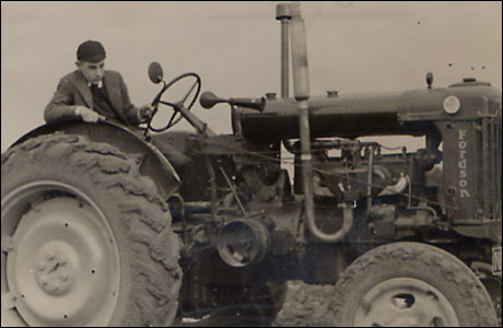 A young Natel Taylor on his tractor