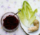 Bowl of dark red paste, romaine lettuce and horseradish root