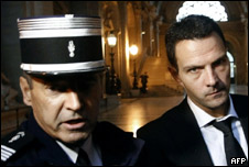 Jerome Kerviel accompanied by a French police officer