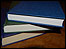 Three books piled on top of each other.