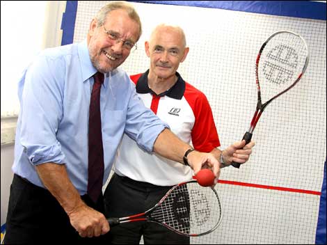 Two men with squash rackets 470