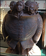 Scultpure of 'seven hundred' men in a waistcoat