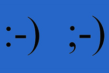 A smiley emoticon and a winking emoticon