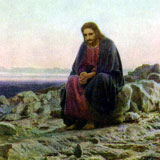 Jesus sitting alone in the desert in an attitude of prayer