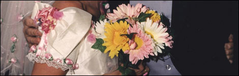 Bride, holding a floral bouquet, and groom at a wedding