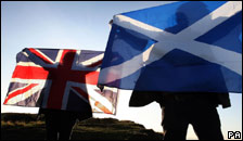 people holding the British and Scottish flags