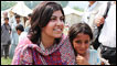 Baroness Warsi with a young flood survivor in Pir Sabak, Pakistan.  Credit: Vicki Francis / Kate Joseph / Department for International Development (DFID)