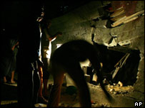 İsrail'in vurduğu hedefi inceleyen Filistinliler