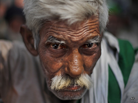 An elderly Indian farmer looks directly at the camera
