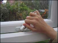 Woman closing a window