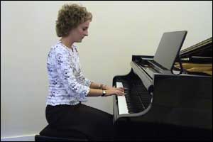 Lisa Mayo playing her piano