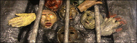 Sculpture of people behind bars