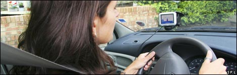Woman driving a car with a sat nav system