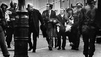 Father Edward Daly leads a group of people carrying the mortally wounded Jackie Duddy, waving a white handkerchief