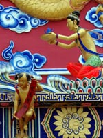 Carved and brightly painted figures of men, dragons and waves ©iStockphoto/Christine Consalves