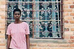 Image: Donatha, a survivor of the Rwandan genocide, outside her new home