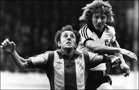 Clive Woods battles for a header against West Brom