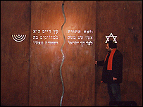 بهروز حشمت، در کنار اثری که از وی در کنيسه ای در اتريش نصب شده است.