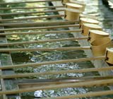 Trough of water with wooden ladles resting on top