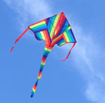 Rainbow striped kite in a clear blue sky