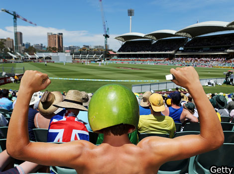 A cricket fan wears a hat made from a watermelon during day two of the second test.