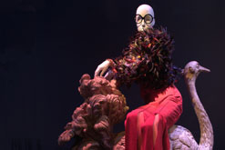 Iris Apfel ensemble Photo © David Gehosky Jacket, Nina Ricci haute couture by Gerard Pipart, late 1970’s. Purple, orange, red and green duck and rooster feathers. Trousers, Moschino, 1997. Red slashed suede. Bangles, Indian, circa 2003. Multicolored rhinestones and metal. Shoes, Anne Klein, circa 1989. Pink silk satin with orange silk faille ribbons.