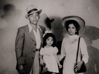 Black and white photograph of a young black family in the 1950s